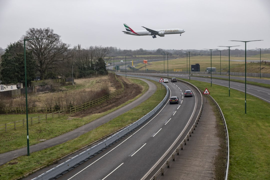 Zoneguard Plus Fence with Multibloc by road with plane flying over A45 Birmingham