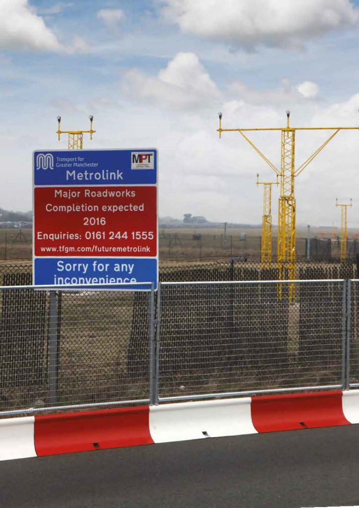 MASS barrier traffic management and perimeter fencing beside a Manchester Metrolink sign