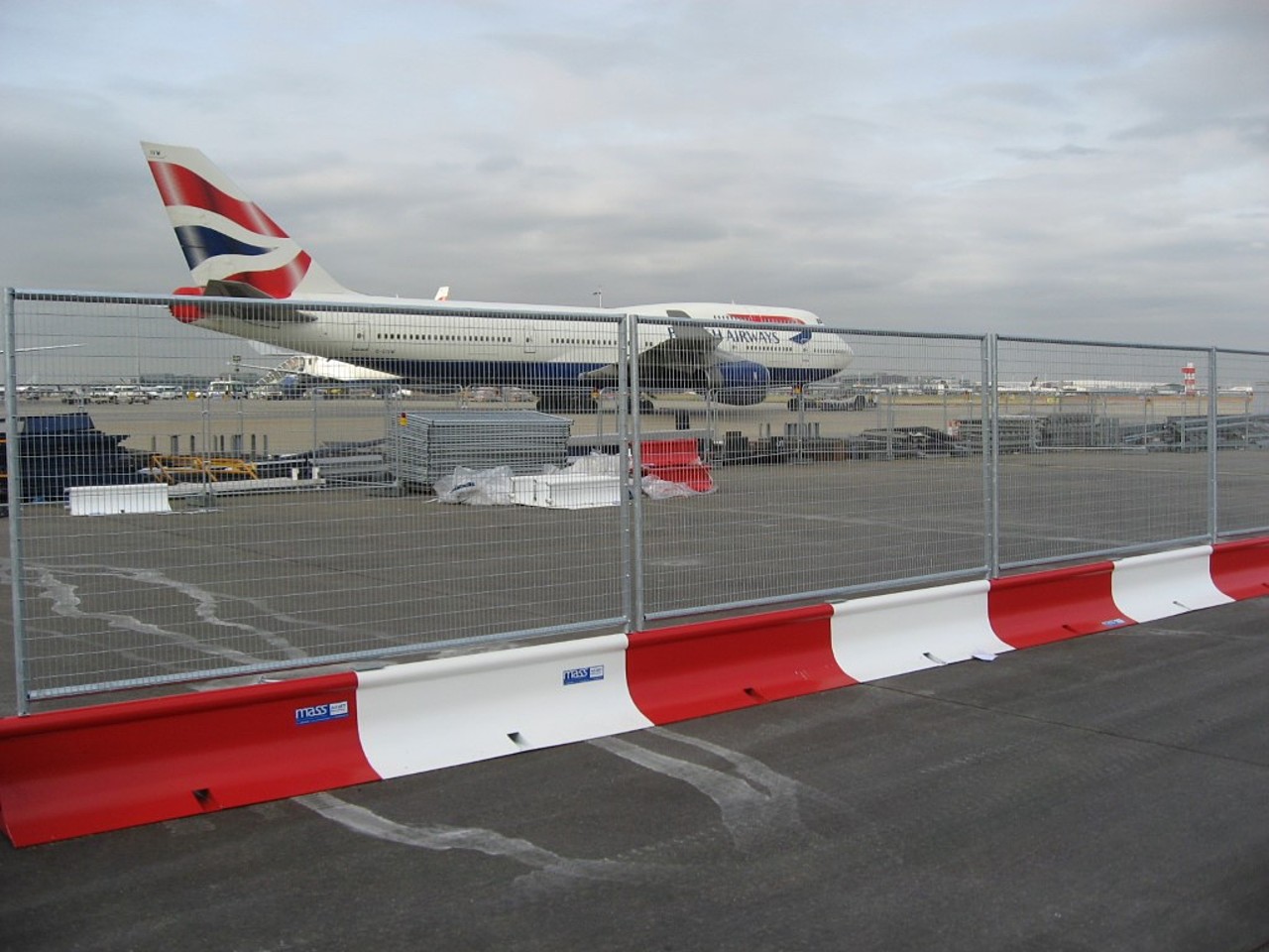 Photograph of MASS Barrier with fencing installed at an airport with British Airways plane behind
